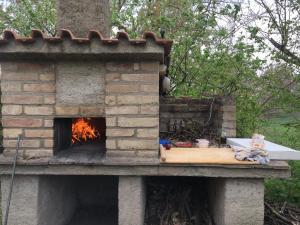 a brick oven with a fire inside of it at La Fratta Art - House in Marsciano