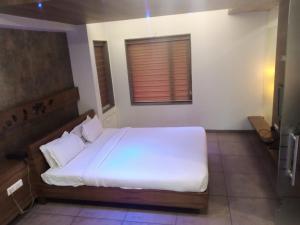 Postel nebo postele na pokoji v ubytování Hotel Kanan