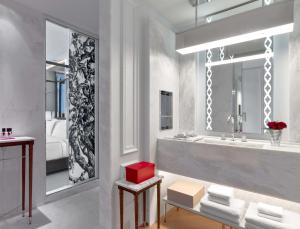 a bathroom with a large sink and a red box at Baccarat Hotel and Residences New York in New York