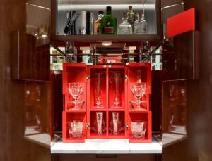a red cabinet with wine glasses in it at Baccarat Hotel and Residences New York in New York