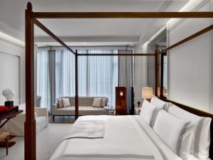 a bedroom with a bed and a living room at Baccarat Hotel and Residences New York in New York