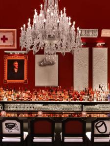 a dining room with a chandelier and a table at Baccarat Hotel and Residences New York in New York