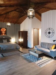 a bedroom with a bed and a couch and a table at Luxury Apartment with balcony in Mytilene