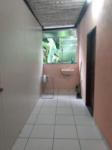 a bathroom with a sink and a mirror at Apartamento em Chácara Aconchegante in Angra dos Reis