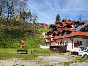 a building with a red umbrella in front of it at Cristal Sinaia in Sinaia