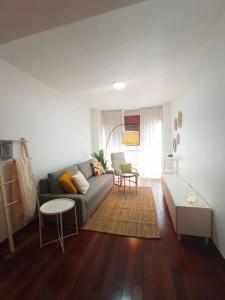 a living room with a couch and a table at Apartamento Jacaranda in Murcia +27 photos