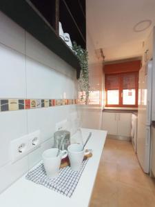 a kitchen with a counter with two cups on it at Apartamento Jacaranda in Murcia