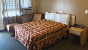 Postel nebo postele na pokoji v ubytování M Star Hotel Mansfield