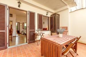 a dining room with a wooden table and chairs at Alfani Deluxe Apartment by Mamo Florence in Florence