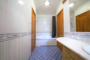 a bathroom with a tub and a sink and a mirror at Old town 2 bedroom / Top location in Rīga