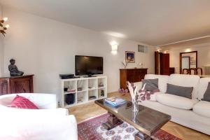 a living room with a white couch and a table at Alfani Deluxe Apartment by Mamo Florence in Florence
