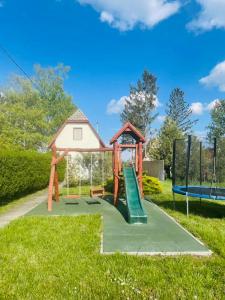 a playground with a slide and a play structure at B&Z Vendégház in Békésszentandrás