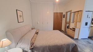 a bedroom with a large bed and a dresser in it at Karystos sea side apartment in Karistos