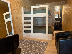 a bedroom with a bunk bed with a mirror at BÜR in Büren an der Aare