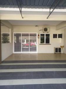 a large empty room with a room with a window at Rumah 127 - Homestay Taiping in Simpang