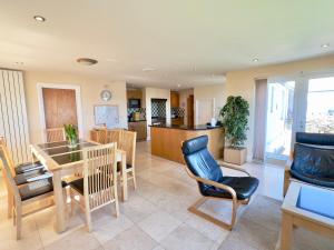 a kitchen and living room with a table and chairs at Pendennis in Padstow +27 photos