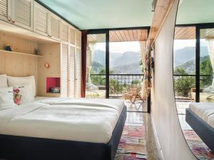 a bedroom with a bed and a large window at Bikini Island & Mountain Port de Soller "Adults only" in Port de Soller