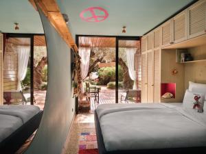 a bedroom with two beds and a view of a patio at Bikini Island & Mountain Port de Soller "Adults only" in Port de Soller