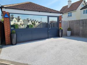 a driveway with a garage door and a house at The Boathouse in Lee-on-the-Solent