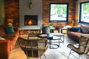 a living room with a couch and a fire place at Papillon Country Resort in Denekamp