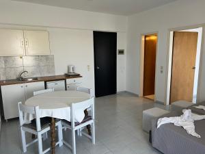 a kitchen and living room with a table and chairs at Smart Accomodation Rhodes by GHH in Rhodes Town