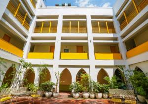 an exterior view of a building with chairs and plants at Bloom Boutique l Signature Towers in Gurgaon