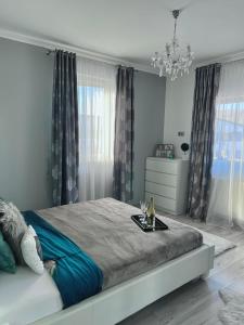 a bedroom with a large bed with a tray on it at Luxurious Accommodation in Floreşti