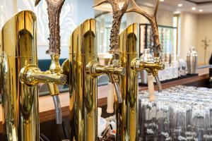 a row of gold glasses on display in a store at Hotel Schloss Hernstein in Hernstein