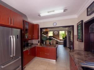 a kitchen with wooden cabinets and a counter top at The Castello at Kruger in Marloth Park