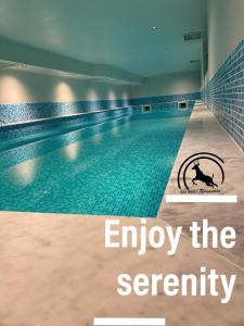 an empty swimming pool with the words enjoy the eternity at СПА Хотел Романтика in Sarnitsa