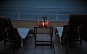 a table with two chairs and a candle on it at Dream apartments limnionas in Limnionas