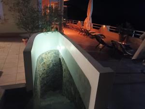 a fountain in the middle of a patio at night at Dream apartments limnionas in Limniónas