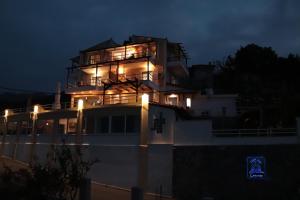 a building with lights on top of it at night at Dream apartments limnionas in Limnionas