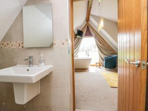 a bathroom with a sink and a tub in a room at Bluebell Cottage in Ulverston +22 photos