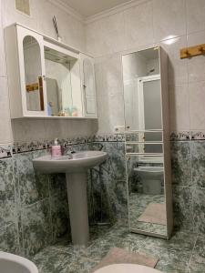 a bathroom with a sink and a mirror at CaYoli in Piedras Blancas