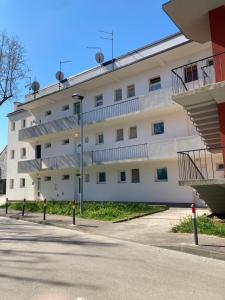a white building with stairs in front of a street at App Goga in Umag