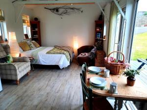 a bedroom with a bed and a table with a dining room at The Wood Cottage in Scarborough