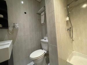 a bathroom with a toilet and a shower and a sink at Hotel Comédie - Place De La Comédie Opéra in Montpellier +62 photos