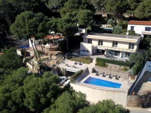 an aerial view of a house with a swimming pool at Setè cel in Begur