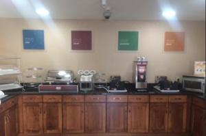 a kitchen with wooden cabinets and appliances on the wall at Comfort Inn & Suites in Caldwell +4 photos