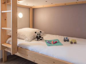 a bunk bed with a teddy bear and toys on it at Résidence Pierre & Vacances La Promenade des Bains in Saint-Raphaël