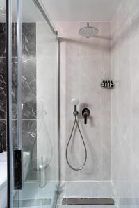 a bathroom with a shower with a glass door at Pianoforte by Febor Hotels&Spa in Istanbul