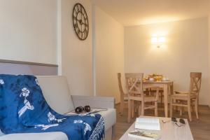 a living room with a couch and a table at Résidence Pierre & Vacances La Promenade des Bains in Saint-Raphaël