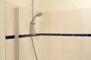 a shower with a shower head in a bathroom at Condillac - Appartement 2 chambres avec ascenseur et Parking in Bordeaux