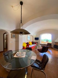 a living room with a glass table and chairs at Sea View con terrazza e giardino in Capri