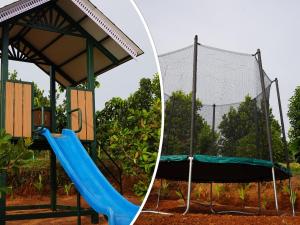 a playground with a slide and a play structure at Johns Village in Cochin