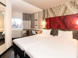 pokój hotelowy z dużym łóżkiem i oknem w obiekcie ibis Amsterdam Centre w Amsterdamie +37 zdjęć