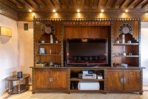 a large wooden entertainment center with a large television at Appartement de luxe Hivernage Gueliz in Marrakesh
