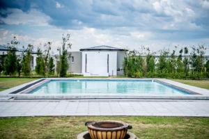 a swimming pool in the yard of a house at 36 Emanzini (Holiday home lake view) in Denysville