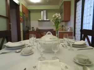 a table with glasses and a teapot on it at La Cabadachan in Vilaboa